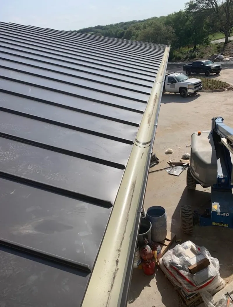 Standing seam panel and gutter detail on a metal roofing jobsite in Niskayuna